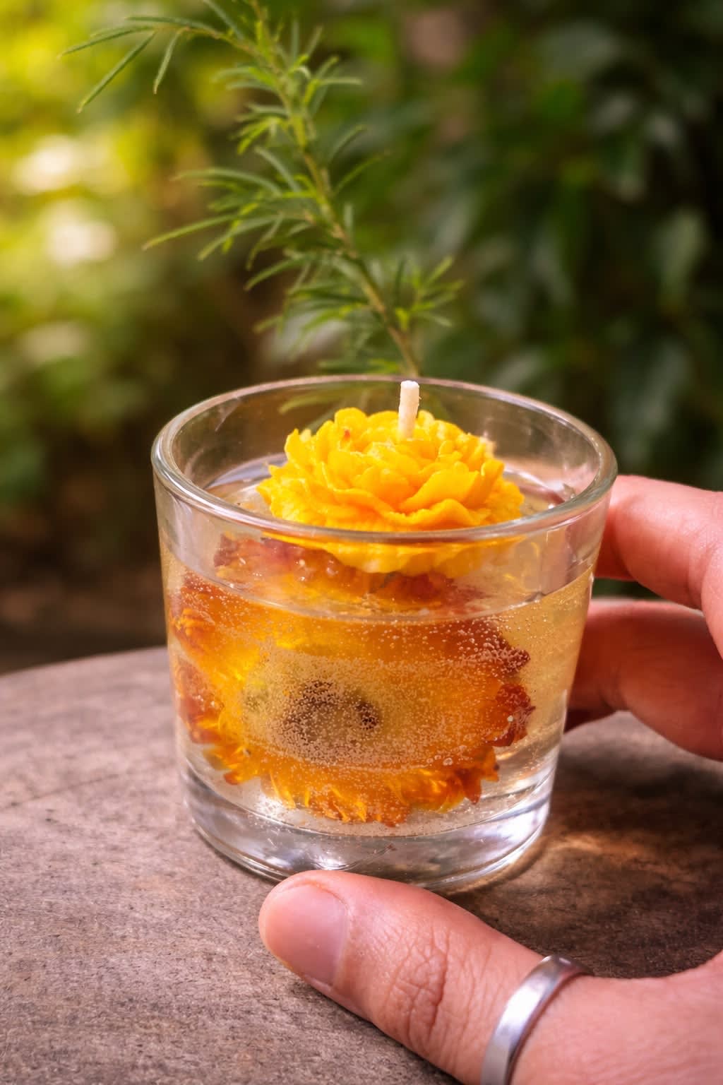 Candle with soft flowers in the foreground