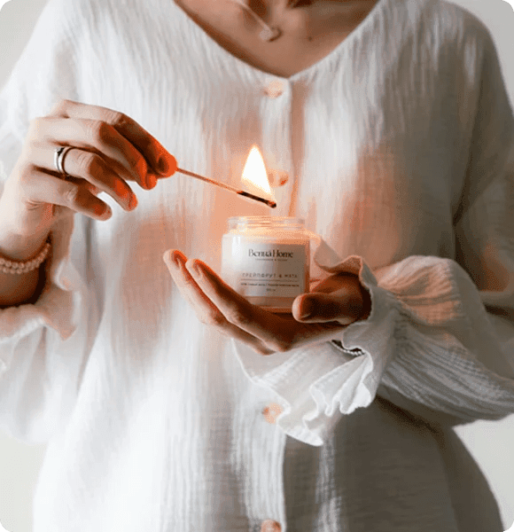 Hands holding a lit candle